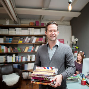 Cameron-and-Company-Owner-holding-books-300-300